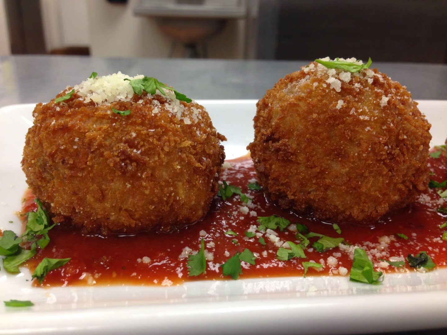 Arancini with with pork ragu served with a marinara sauce