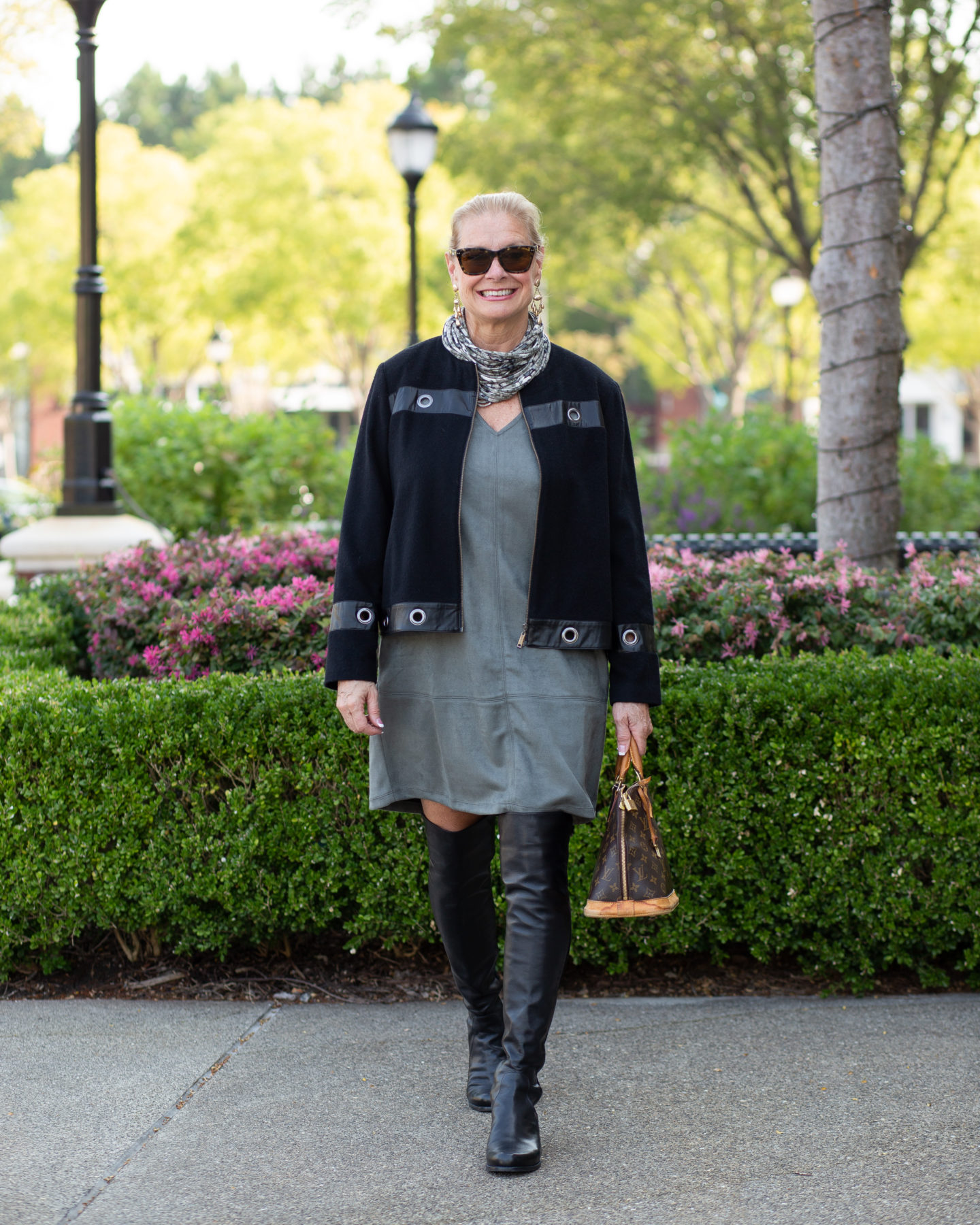 Robin is wearing a faux suede jumper from Peach, black moto jacket, and OTK boots