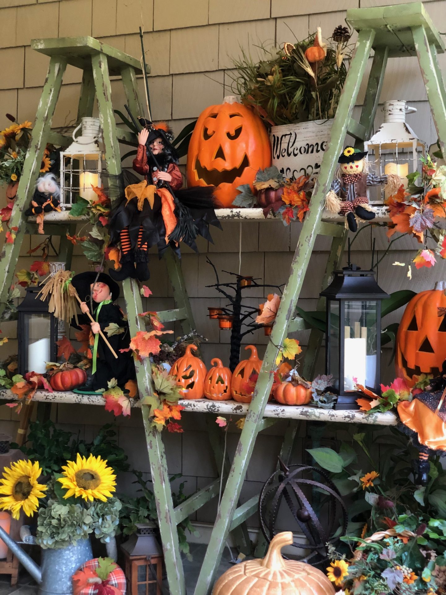 Halloween decor on the porch featuring old and new decorations