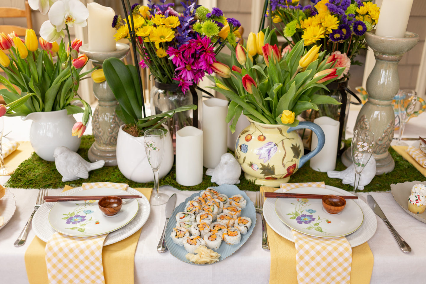 Adding a variety of heights to your flowers and candles also make for a visually appealing centerpiece.