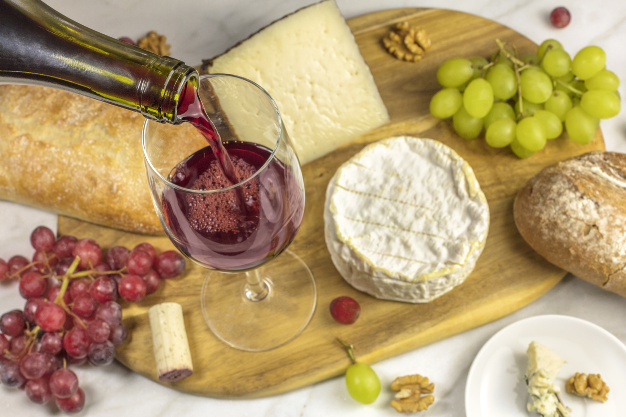 Enjoy a glass of wine with cheeses and bread. before dinner