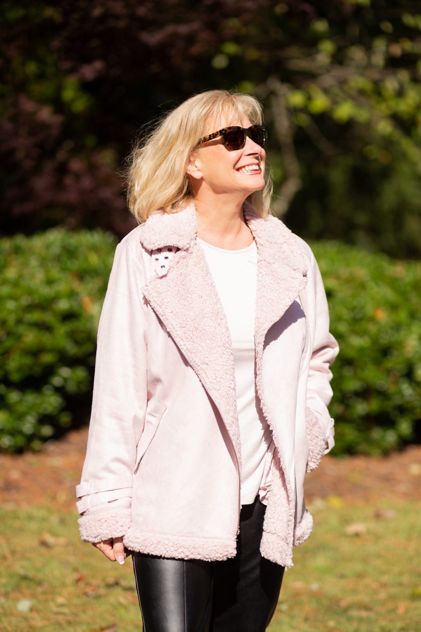 Embrace après style from the comfort of your home with this relaxed aviator jacket. Designed with edgy buckle details and a stylish asymmetric zipper as well as cozy faux sherpa throughout, for the ultimate winter statement. I