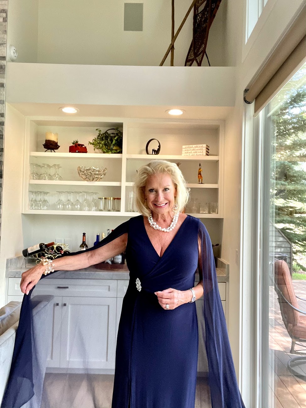 You can't go wrong with a cape dress to do the talking; featuring a v-neckline, front slit, wrap silhouette with brooch detailing, and a chiffon cape at the back in all its dreamy glory.