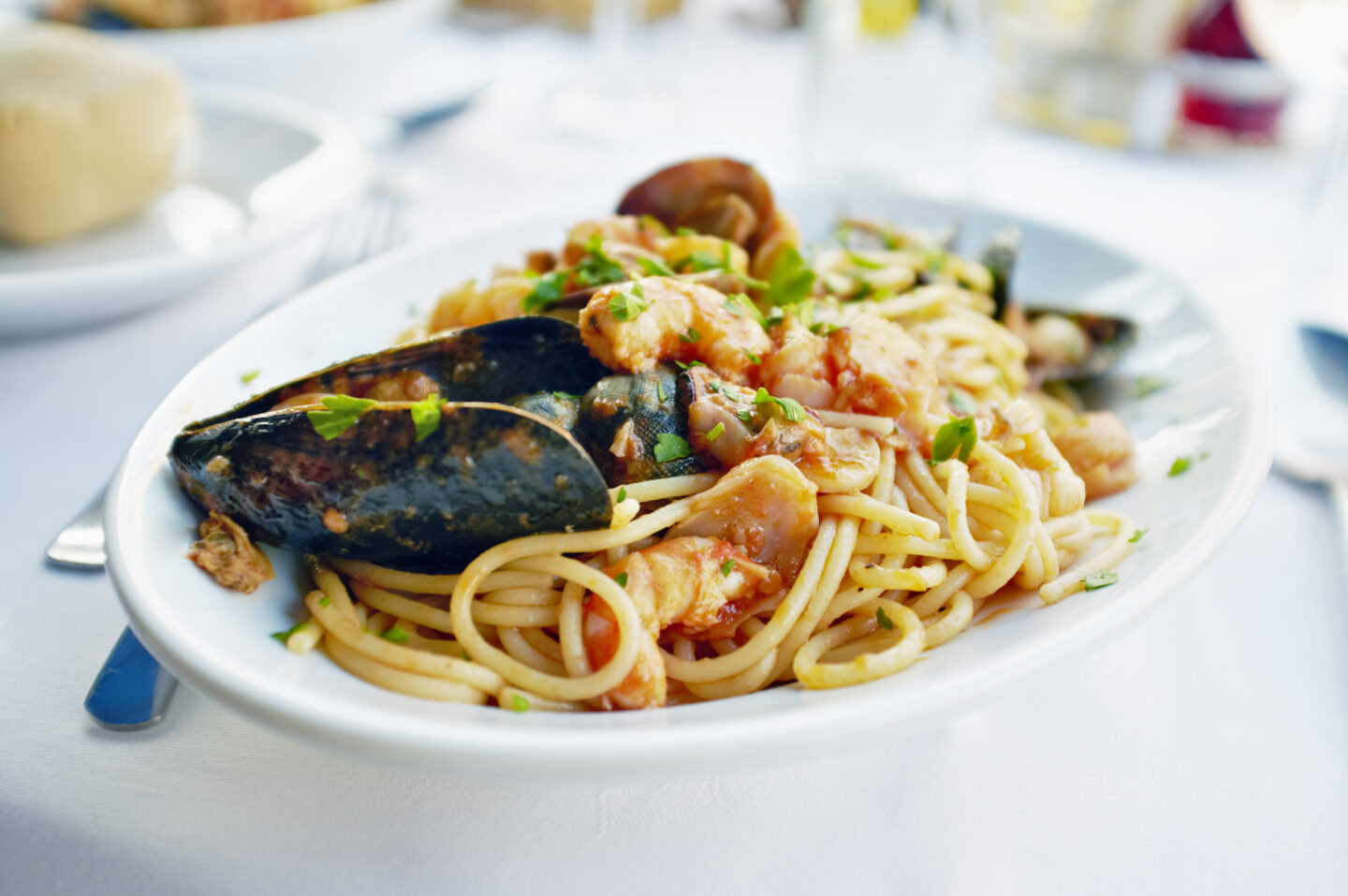Fresh Seafood pasta - Spaghetti, clams, shrimps and squid, served over pasta