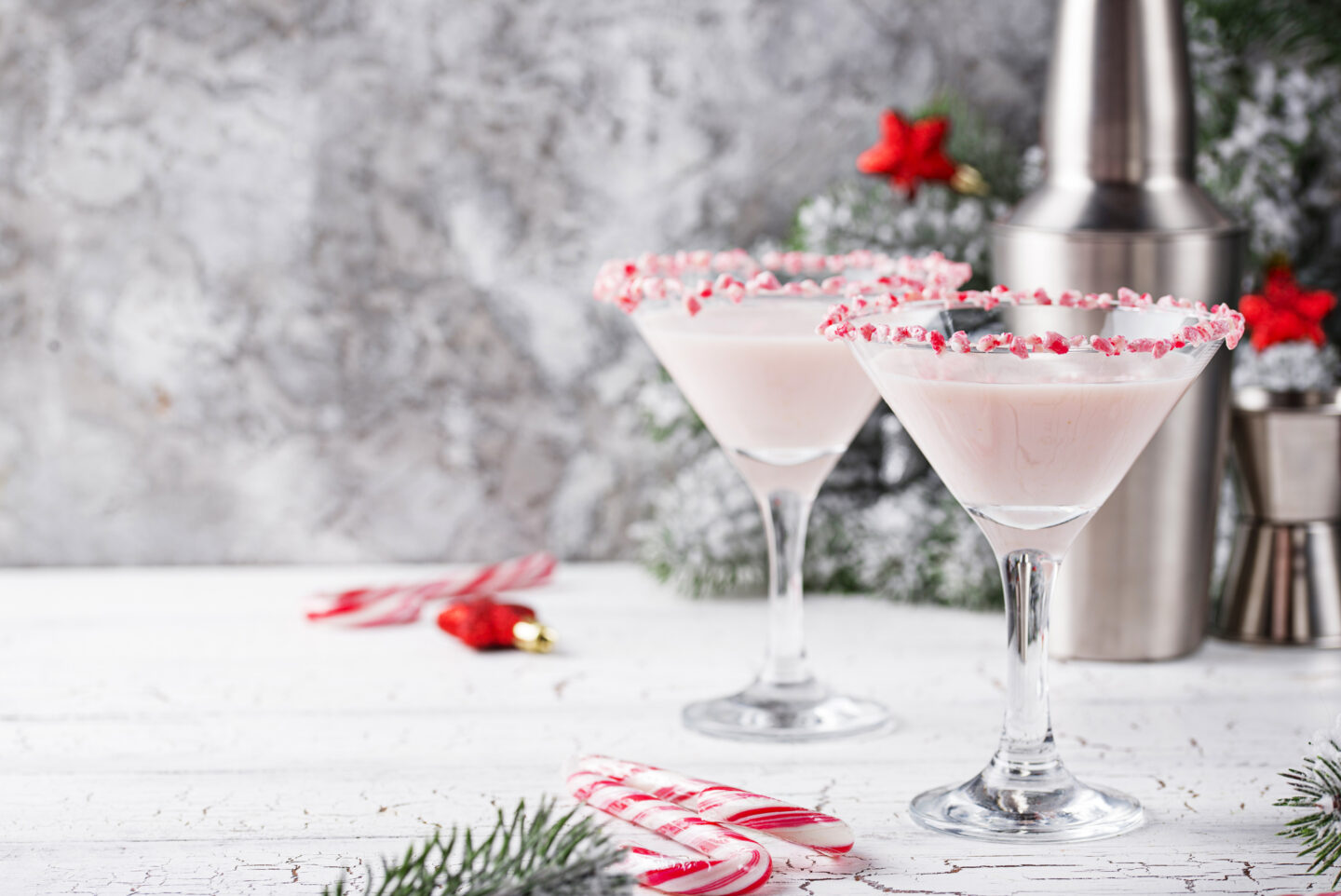 Pink peppermint martini with candy cane rim. Christmas cocktail