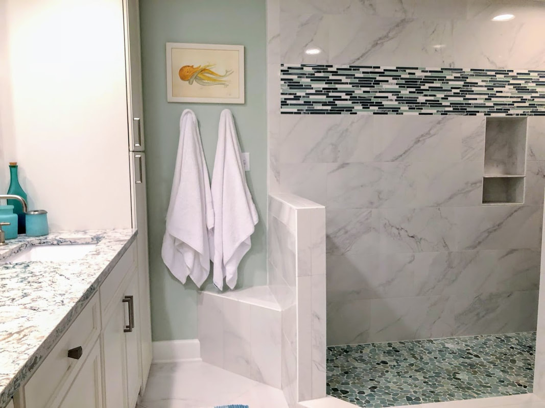 Designed by Robin LaMonte. This pebble tile flooring is slip resistant in this walk in shower