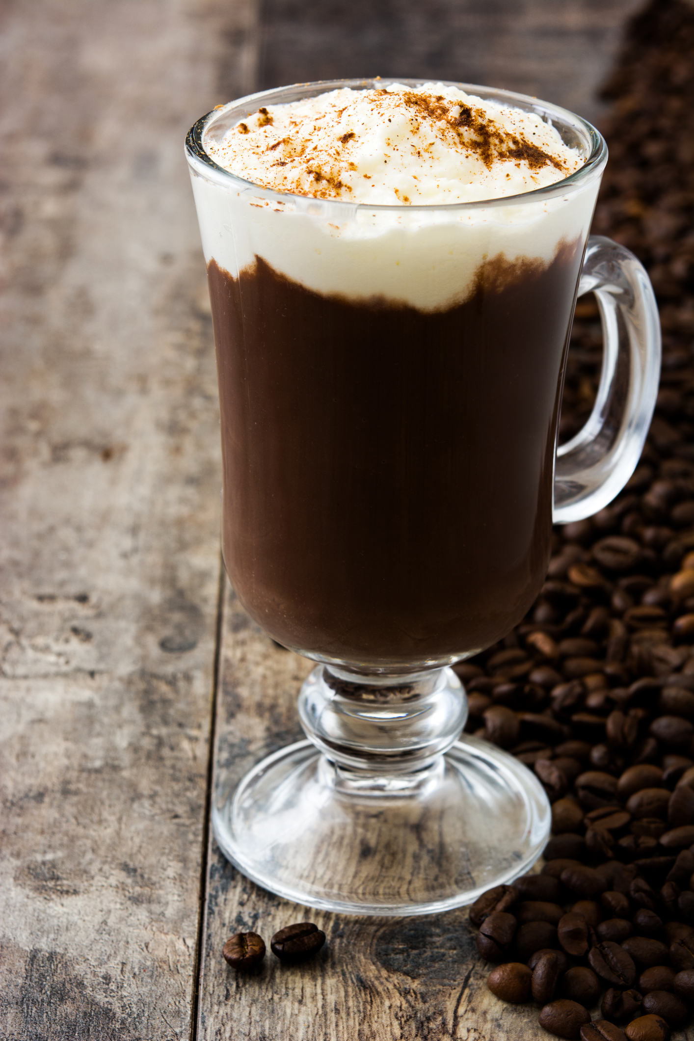 Irish coffee in glass on wooden table
