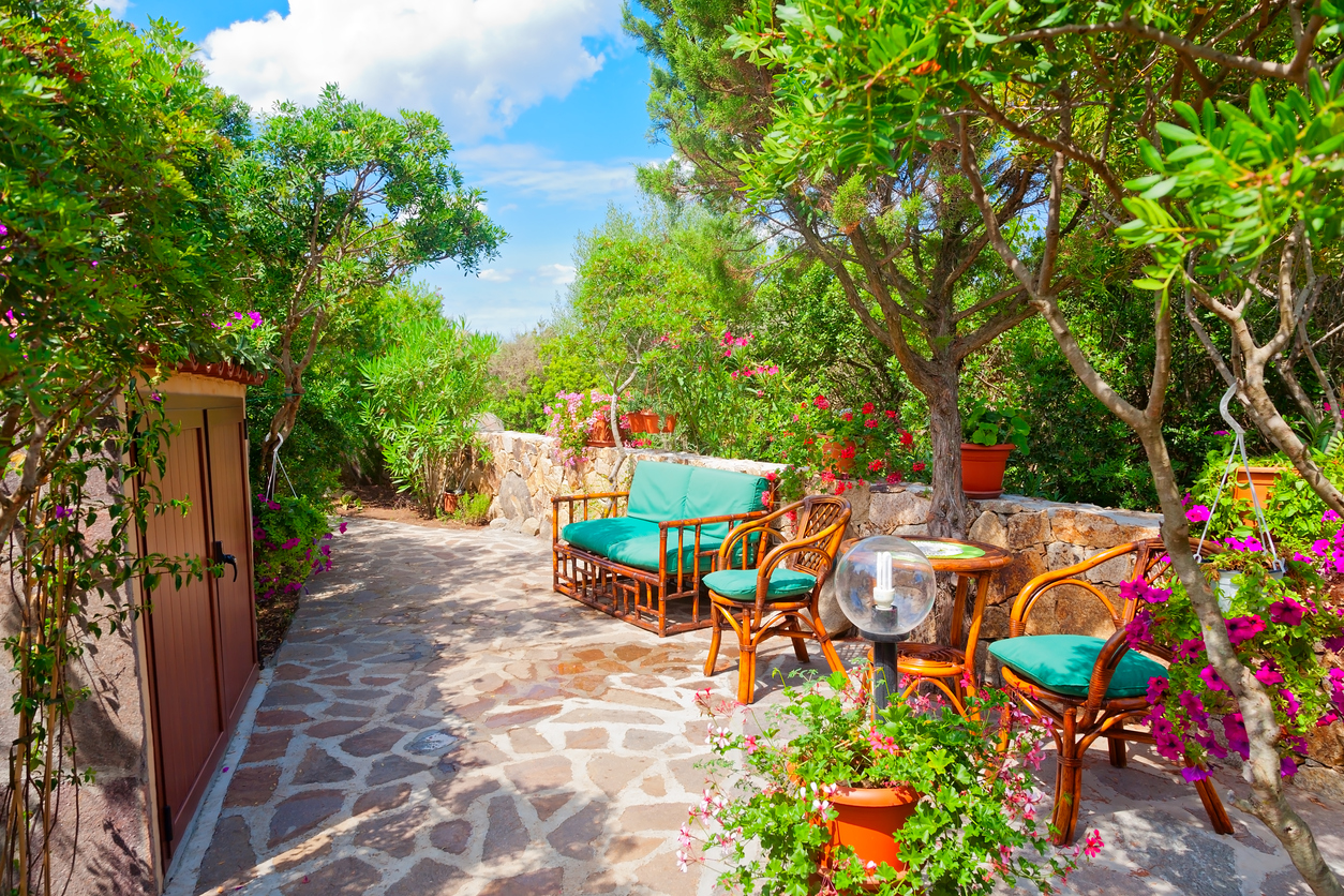 Outdoor green garden beach patio wooden bench in backyard porch of home with nobody in Sardinia tropical house