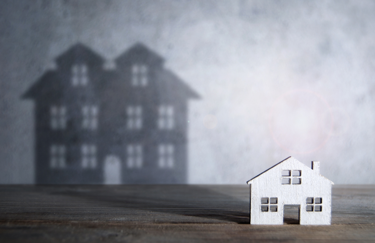 Shadow of a large house from a miniature home