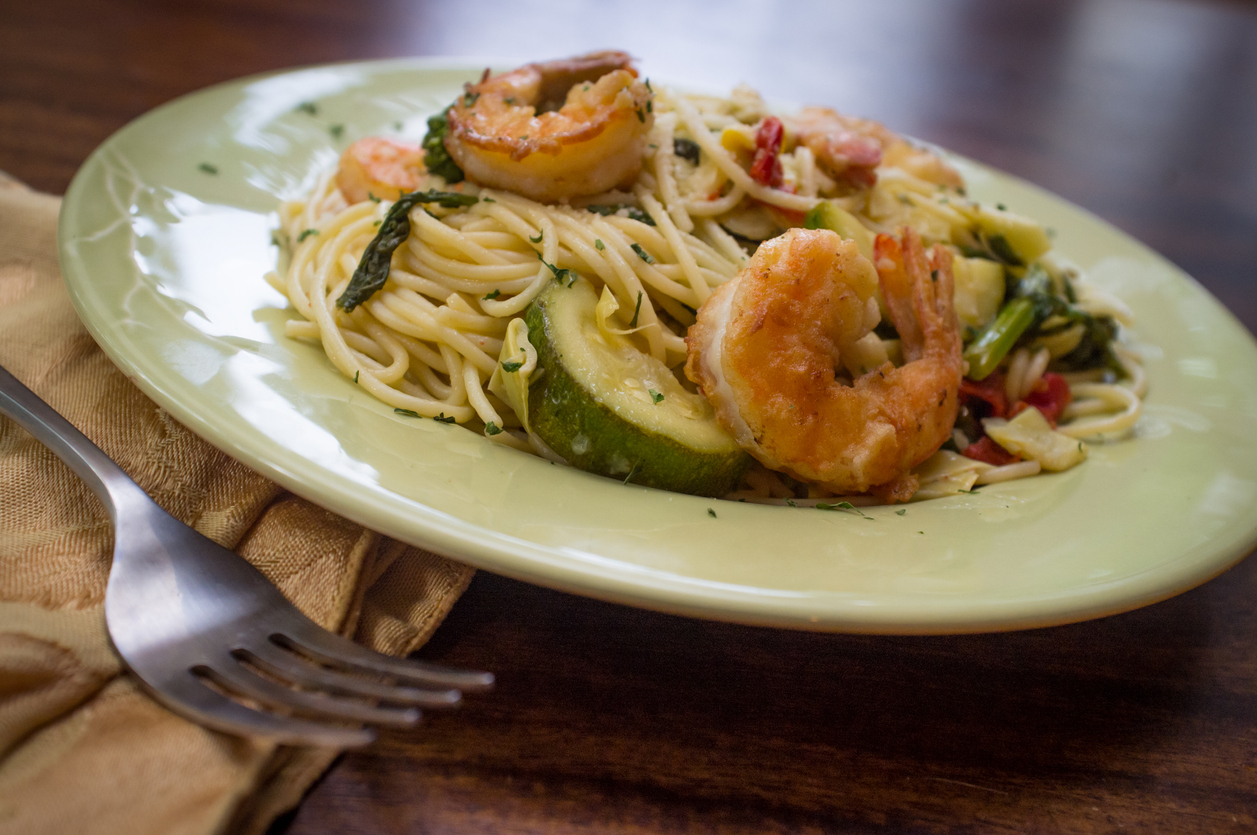 Shrimp pasta primavera with white wine sauce and green vegetables