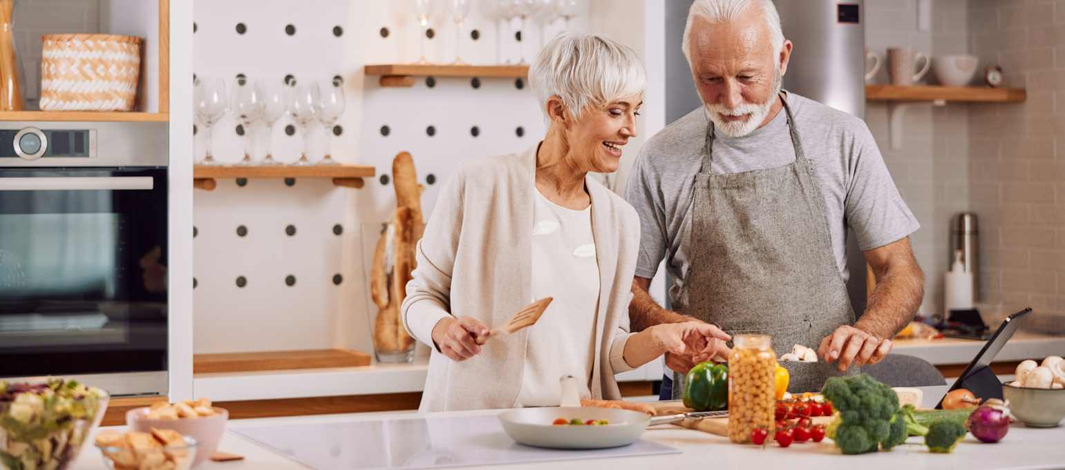 happy and healthy seniors prepare vegan food at home